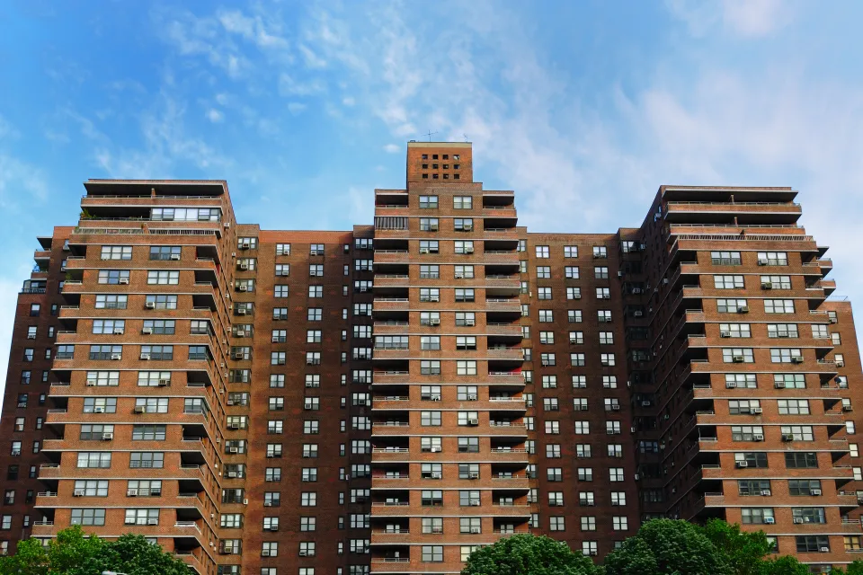 Looking up at red brick public housnig high-rise building in New York City